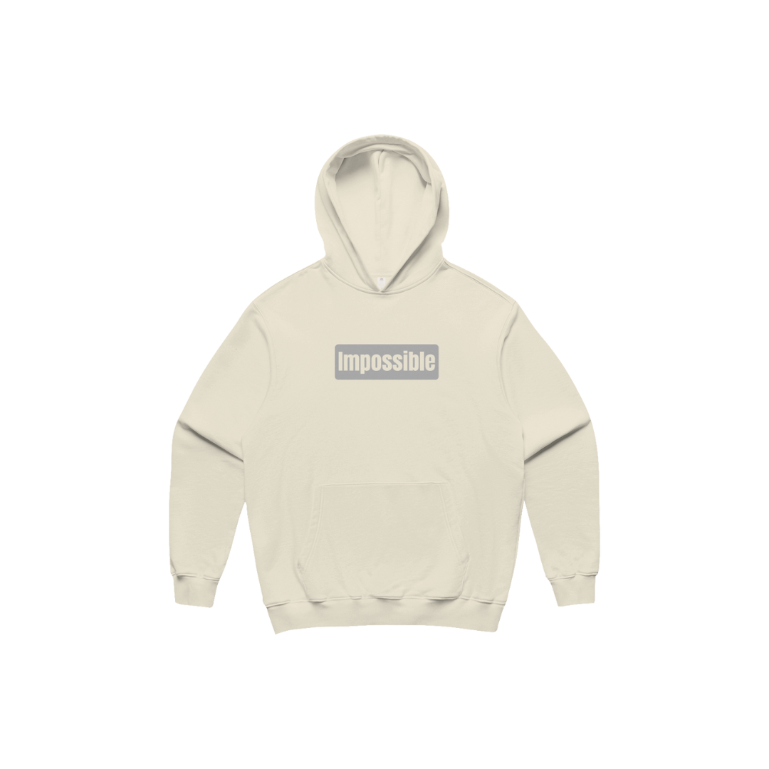 Beige hoodie with 'impossible' text on a white background