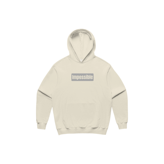 Beige hoodie with 'impossible' text on a white background